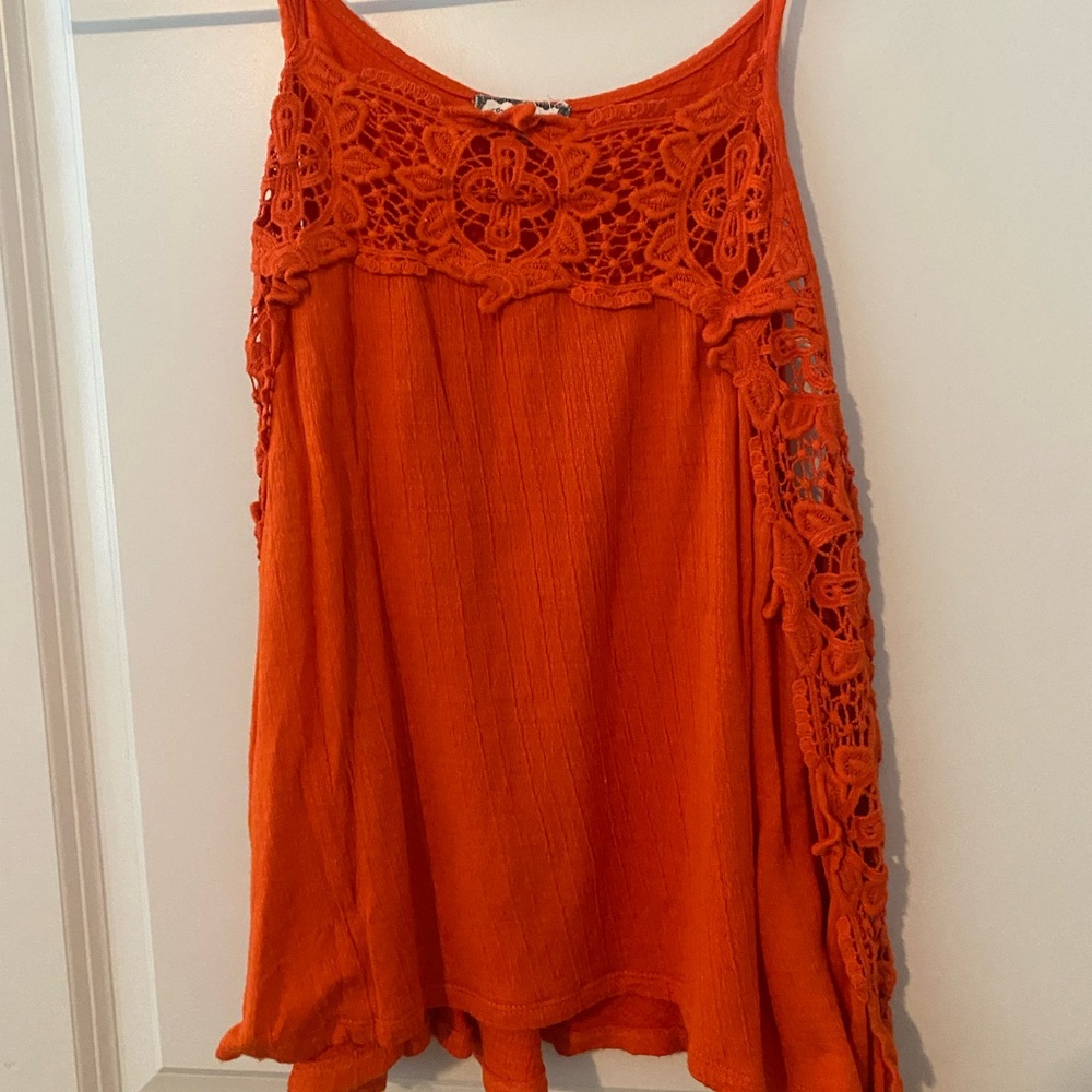Orange tank top. Lace detailing along side. Size small.